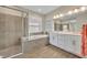 Spa-like main bathroom with a soaking tub, glass-enclosed shower, and a double vanity at 1511 Goblet Cove St, Kissimmee, FL 34746