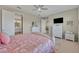 Bright main bedroom with a comfortable bed, neutral colors, and a glimpse into the ensuite bathroom at 1511 Goblet Cove St, Kissimmee, FL 34746