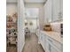 Walk-in pantry with ample shelving and storage space, adjacent to the kitchen at 1511 Goblet Cove St, Kissimmee, FL 34746
