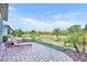 Relaxing paver patio overlooking the spacious yard with tropical landscaping, great for outdoor living at 1511 Goblet Cove St, Kissimmee, FL 34746