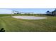 Sand volleyball court surrounded by green grass. This area is great for summer fun at 1511 Goblet Cove St, Kissimmee, FL 34746