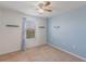 Spacious bedroom with light blue walls, ceiling fan, and window coverings at 15508 Blackbead St, Winter Garden, FL 34787