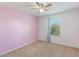 Charming bedroom with pink walls and a ceiling fan at 15508 Blackbead St, Winter Garden, FL 34787