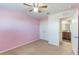 Spacious bedroom with pink walls and en-suite bathroom access at 15508 Blackbead St, Winter Garden, FL 34787