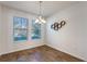 Bright dining room with hardwood floors and large windows at 15508 Blackbead St, Winter Garden, FL 34787