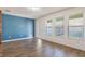 Gathering room with blue accent wall and hardwood floors at 15508 Blackbead St, Winter Garden, FL 34787