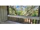 Screened balcony overlooking a wooded area, offering a private retreat at 203 Crown Oaks Way # 202, Longwood, FL 32779