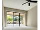 Spacious bedroom with sliding glass doors leading to a balcony at 203 Crown Oaks Way # 202, Longwood, FL 32779