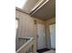 Private condo entrance with a light fixture and railing at 203 Crown Oaks Way # 202, Longwood, FL 32779