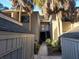 Exterior view of condo building with walkway, landscaping, and private storage units at 203 Crown Oaks Way # 202, Longwood, FL 32779