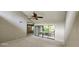Bright living room with vaulted ceiling, sliding glass doors, and carpeting at 203 Crown Oaks Way # 202, Longwood, FL 32779