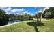 Community pond with lush landscape at 203 Crown Oaks Way # 202, Longwood, FL 32779