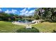 Serene pond with walking path and dock at 203 Crown Oaks Way # 202, Longwood, FL 32779