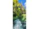 River with lush greenery and a small waterfall at 203 Crown Oaks Way # 202, Longwood, FL 32779