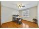 This bedroom features wood floors, neutral paint, and a ceiling fan at 2537 Lanier Rd, Kissimmee, FL 34744