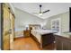 Cozy bedroom with a ceiling fan, window, and dark wood furniture at 2537 Lanier Rd, Kissimmee, FL 34744