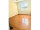 A vacant bedroom is brightened by natural light and features hardwood floors at 2537 Lanier Rd, Kissimmee, FL 34744
