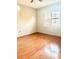 Bright bedroom featuring hardwood floors and a window with white blinds allowing natural light at 2537 Lanier Rd, Kissimmee, FL 34744