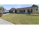 Well-maintained single-story home showcasing a green lawn, brick driveway, and attached garage at 2537 Lanier Rd, Kissimmee, FL 34744