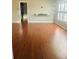 Spacious living room with hardwood floors, a sleek entertainment center, and ample natural light at 2537 Lanier Rd, Kissimmee, FL 34744