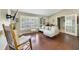 Inviting living room with hardwood floors, comfortable seating, and ample natural light through a large window at 2537 Lanier Rd, Kissimmee, FL 34744