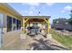 Covered patio with a dining set, a brick patio, and a view of the backyard at 2537 Lanier Rd, Kissimmee, FL 34744