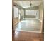 Bright sunroom featuring tile flooring, multiple windows, and a ceiling fan for comfort at 2537 Lanier Rd, Kissimmee, FL 34744