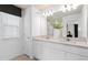 Double vanity bathroom with white cabinets, quartz countertops, and large mirror at 2575 Winsome Way, Davenport, FL 33896
