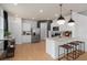 Modern kitchen with white cabinets, stainless steel appliances, and island with seating at 2575 Winsome Way, Davenport, FL 33896
