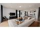Open concept living room with sectional sofa, hardwood floors, and views to kitchen at 2575 Winsome Way, Davenport, FL 33896