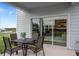 Relaxing patio with table and chairs, overlooking the backyard at 2575 Winsome Way, Davenport, FL 33896