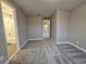 Bedroom with carpet, access to bathroom, and hallway view at 348 Birkdale Dr, Daytona Beach, FL 32124