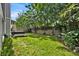 Serene backyard with lush grass, hot tub, and privacy fence at 377 River Chase Dr, Orlando, FL 32807