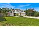 Two-story house with gray siding, brick accents, and a well-maintained lawn at 377 River Chase Dr, Orlando, FL 32807