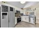 Modern kitchen with white cabinets, stainless steel appliances, and a tile backsplash at 377 River Chase Dr, Orlando, FL 32807