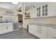 Modern kitchen with white cabinets, stainless steel appliances, and a tile backsplash at 377 River Chase Dr, Orlando, FL 32807