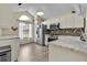 Modern kitchen with white cabinets, stainless steel appliances, and a tile backsplash at 377 River Chase Dr, Orlando, FL 32807