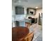 Well-lit kitchen with stainless steel refrigerator, gray cabinets, tile backsplash, and modern appliances at 417 Benita St, Kissimmee, FL 34744