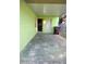 Covered patio with lime green walls and a view of a doorway into the house at 417 Benita St, Kissimmee, FL 34744