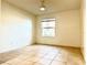 Bedroom with tile floor and large window at 4524 Commander Dr # 1613, Orlando, FL 32822
