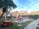Community picnic tables and grills by a pond at 4524 Commander Dr # 1613, Orlando, FL 32822