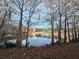Serene pond view with mature trees and reflections at 4524 Commander Dr # 1613, Orlando, FL 32822
