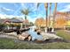 Serene pond with landscaping and palm trees at 4524 Commander Dr # 1613, Orlando, FL 32822