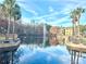 Community pond with fountain and palm trees at 4524 Commander Dr # 1613, Orlando, FL 32822