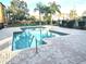 Community pool with brick patio and lounge chairs at 4524 Commander Dr # 1613, Orlando, FL 32822