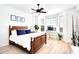 Spacious bedroom with a king-size bed, hardwood floors, and a home office at 4623 Rivers Edge Village Ln # 6403, Ponce Inlet, FL 32127