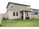Grass backyard with a patio, sitting area, and privacy fence at 494 Amadoras Way, St Cloud, FL 34771