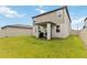 A beautiful two-story home boasts a large, green backyard with a covered patio perfect for outdoor entertaining at 494 Amadoras Way, St Cloud, FL 34771