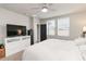 Bright bedroom with carpet, a TV on a dresser, and two windows for plenty of natural light at 494 Amadoras Way, St Cloud, FL 34771