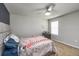 Comfortable bedroom with carpeting, ceiling fan, closet, and a side table providing ample space for reading at 494 Amadoras Way, St Cloud, FL 34771
